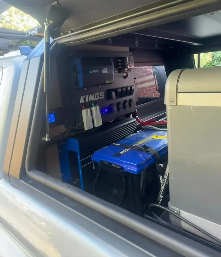 Ute canopy with a Kings battery, charger and switch panel next to a fridge